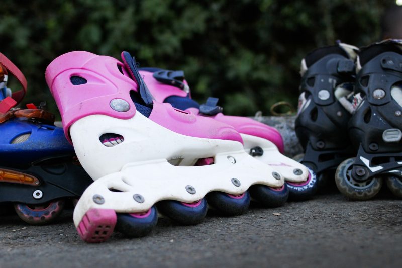 Close-up of colorful rollerblades on pavement, perfect for a weekend activity in Springdale, AR.