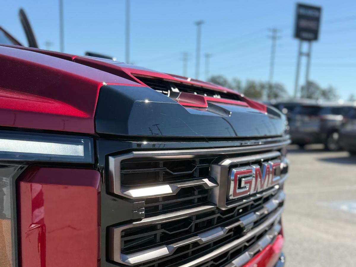 Close-up of a red GMC truck grille at Crain Buick GMC of Springdale in Northwest Arkansas.